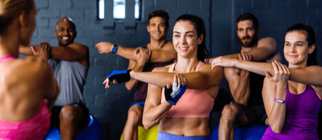 fitness instructor leading a group class with exercises