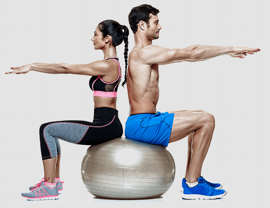 a man and woman sitting back-to-back on a fitness exercise ball and doing arm stretches