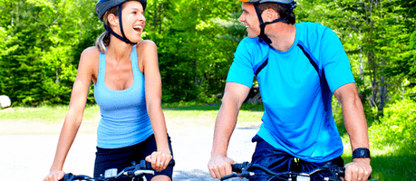 man and woman biking in a park